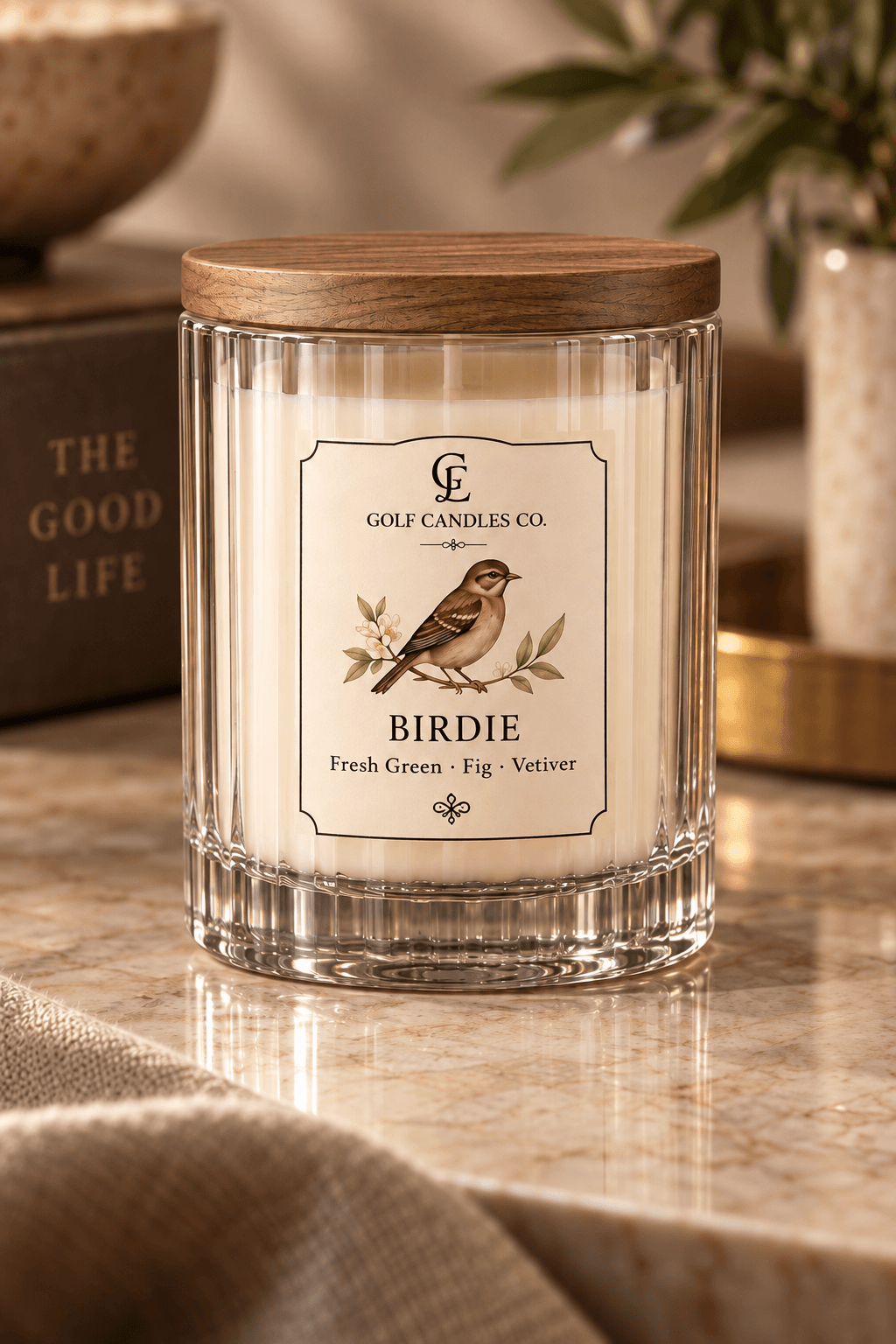 Birdie candle by Golf Candles Co., with cream wax in a clear ribbed glass jar, a wooden lid and a cream label illustrated with a bird.