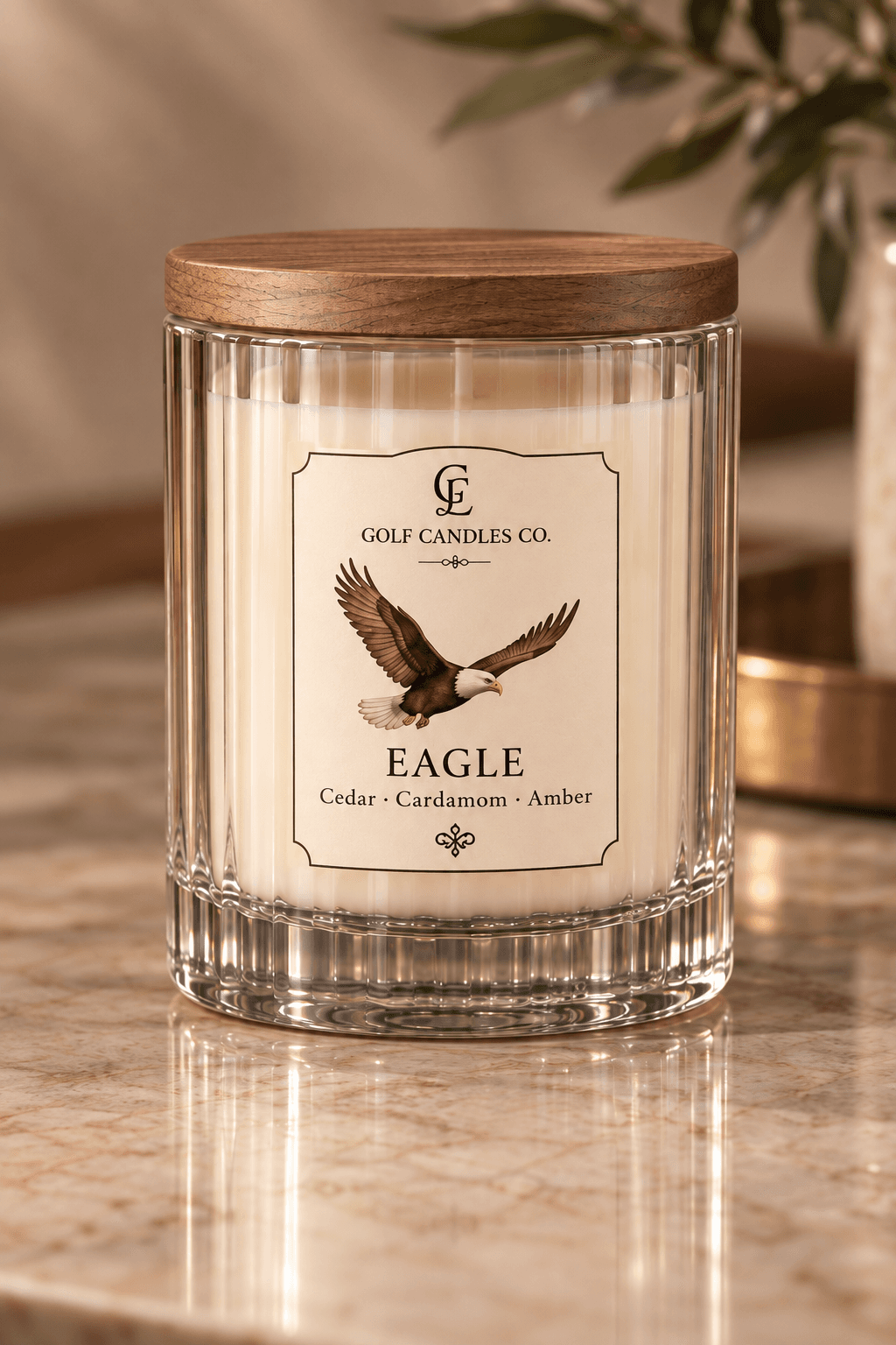 Eagle candle by Golf Candles Co., with cream wax in a clear ribbed glass jar, a wooden lid and a cream label illustrated with an eagle.